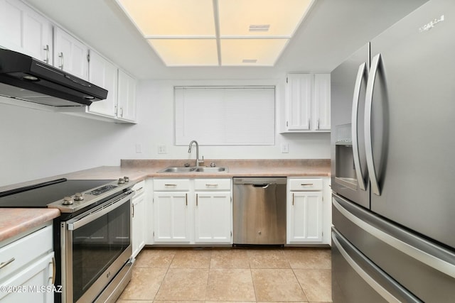 kitchen featuring white cabinetry, sink, light tile patterned floors, and appliances with stainless steel finishes