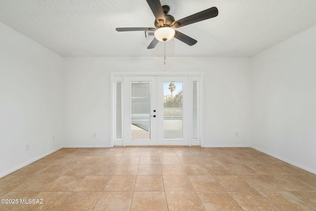 tiled empty room featuring ceiling fan, a textured ceiling, and french doors