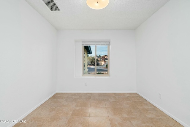 spare room featuring a textured ceiling