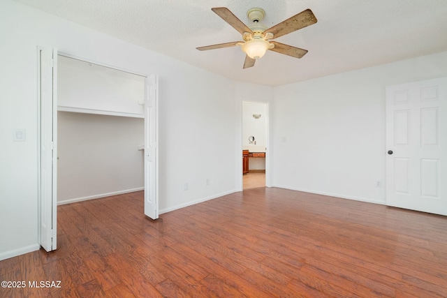 unfurnished room featuring ceiling fan, hardwood / wood-style floors, and a textured ceiling