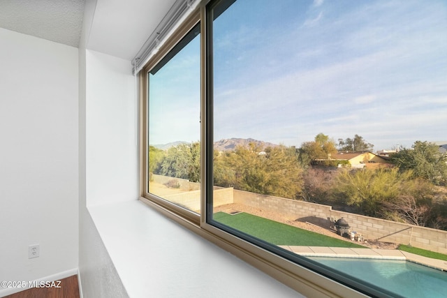 unfurnished sunroom featuring a mountain view