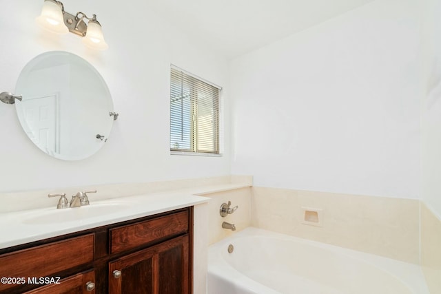 bathroom featuring vanity and a bath