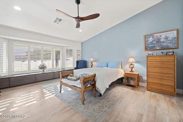 bedroom featuring vaulted ceiling, light wood-type flooring, and ceiling fan