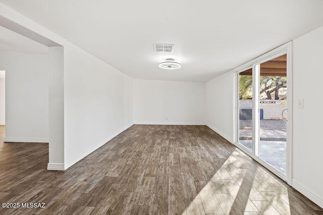 empty room featuring dark wood-type flooring