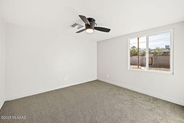 spare room featuring ceiling fan and carpet