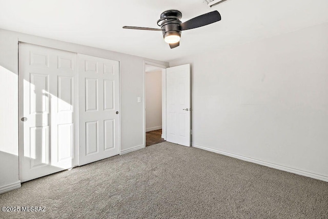 unfurnished bedroom with carpet floors, a closet, and ceiling fan