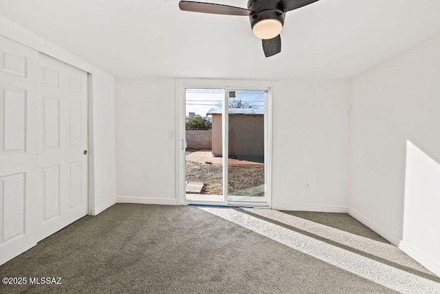 carpeted spare room with ceiling fan