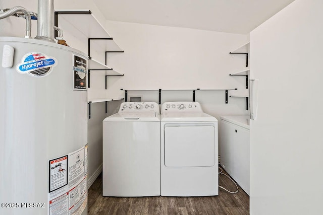 laundry area featuring gas water heater, dark hardwood / wood-style floors, and washing machine and clothes dryer