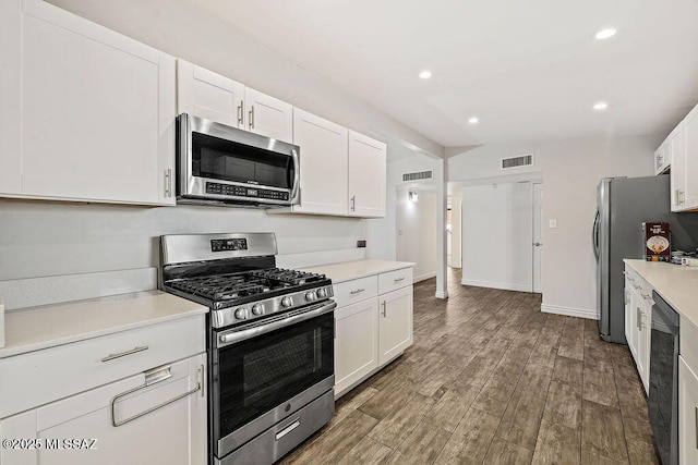 kitchen featuring stainless steel appliances, dark hardwood / wood-style floors, white cabinets, and beverage cooler