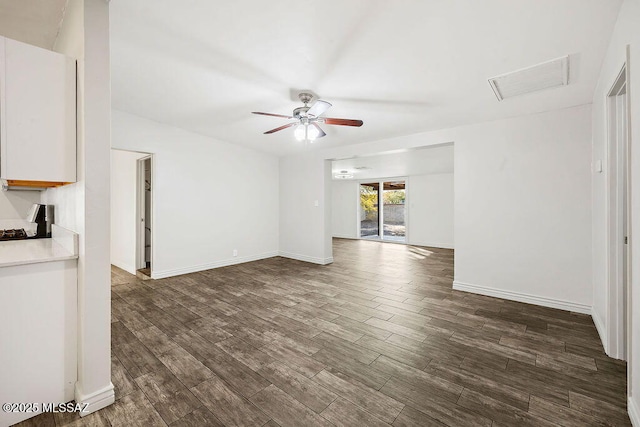 unfurnished living room with dark wood-type flooring and ceiling fan