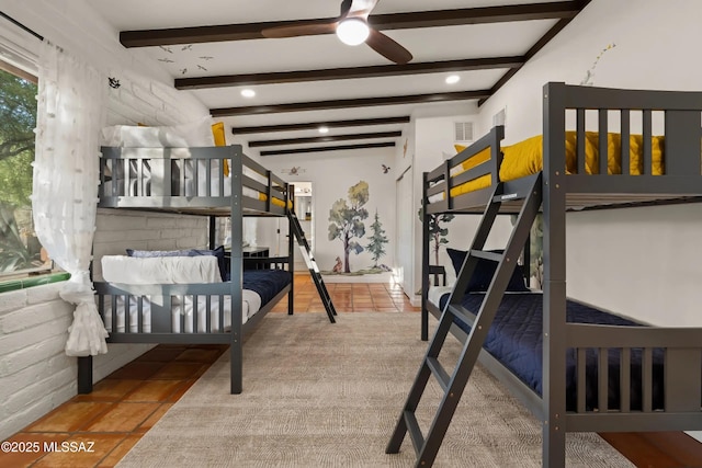 tiled bedroom with brick wall and beam ceiling