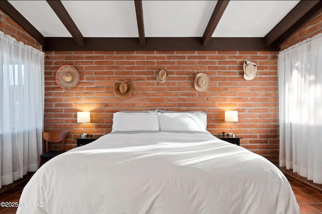 bedroom featuring brick wall and beam ceiling