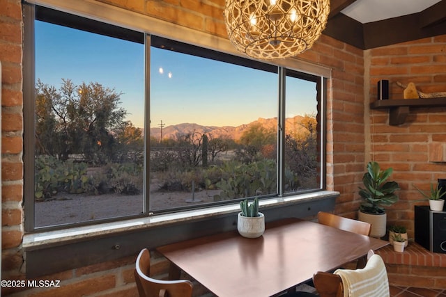 unfurnished dining area featuring brick wall