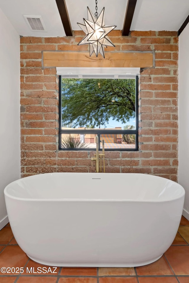 bathroom with a bathtub, tile patterned floors, and beamed ceiling