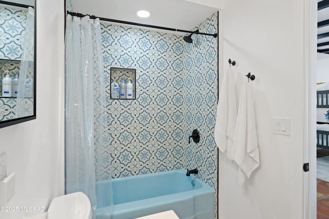 bathroom featuring shower / tub combo and toilet