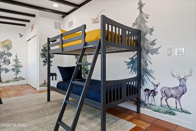 tiled bedroom featuring beam ceiling