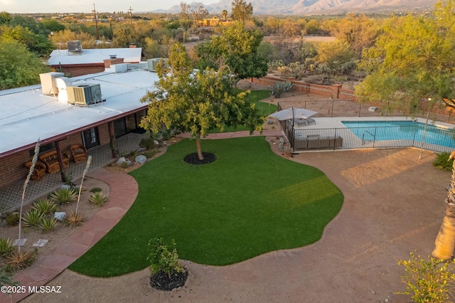 view of swimming pool with central AC, a lawn, and a patio area