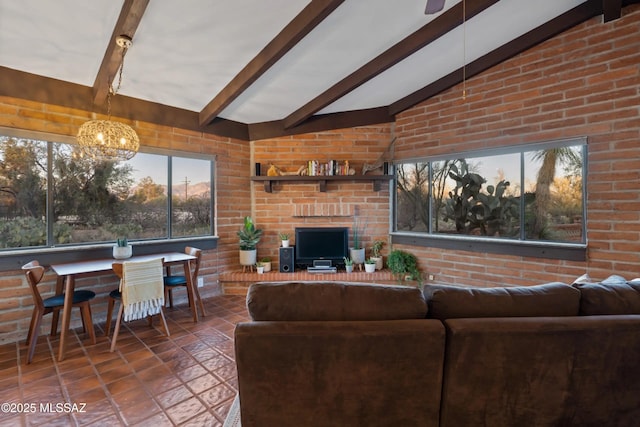 living room with lofted ceiling with beams, brick wall, tile patterned flooring, and a chandelier