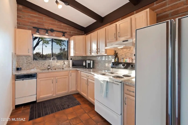 kitchen featuring sink, white appliances, lofted ceiling with beams, dark tile patterned flooring, and decorative backsplash