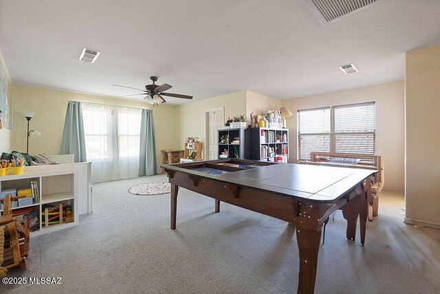 recreation room with ceiling fan and carpet flooring