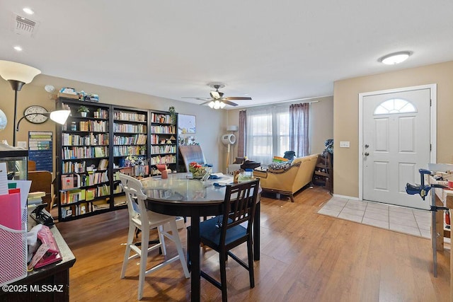 dining area with hardwood / wood-style flooring and ceiling fan