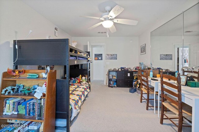 bedroom featuring ceiling fan and carpet