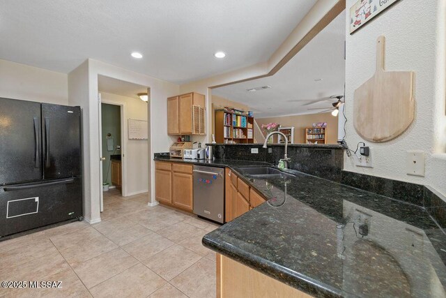 kitchen with dishwasher, sink, dark stone counters, kitchen peninsula, and black fridge