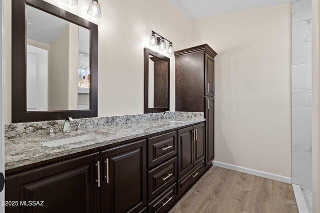 bathroom featuring ceiling fan, hardwood / wood-style floors, and vanity