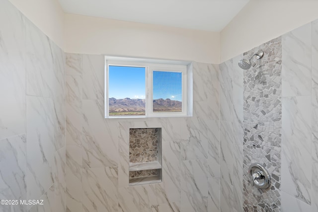 bathroom with tiled shower