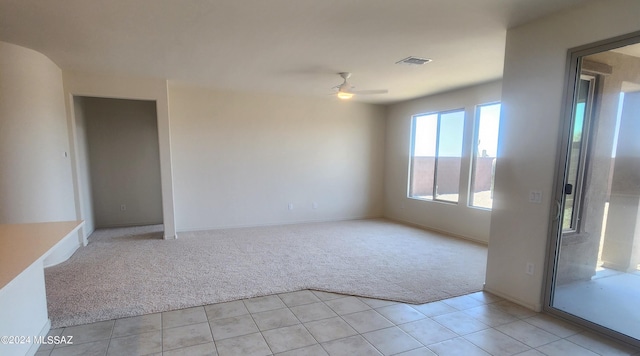 carpeted spare room featuring ceiling fan