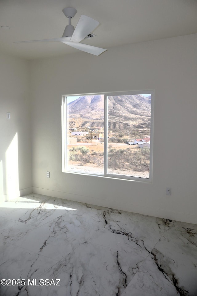 spare room with ceiling fan