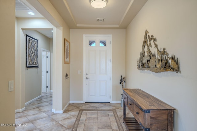 entrance foyer featuring a raised ceiling