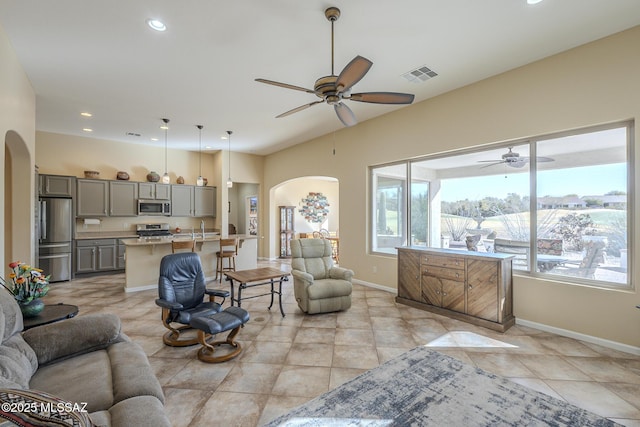 tiled living room with ceiling fan