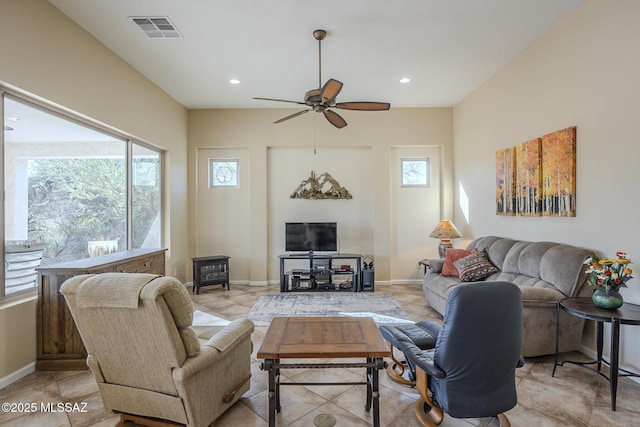 living room featuring ceiling fan and plenty of natural light