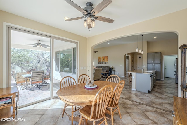 tiled dining room featuring sink and ceiling fan