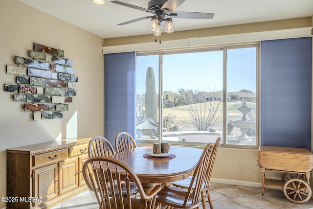 tiled dining area with ceiling fan and a wealth of natural light