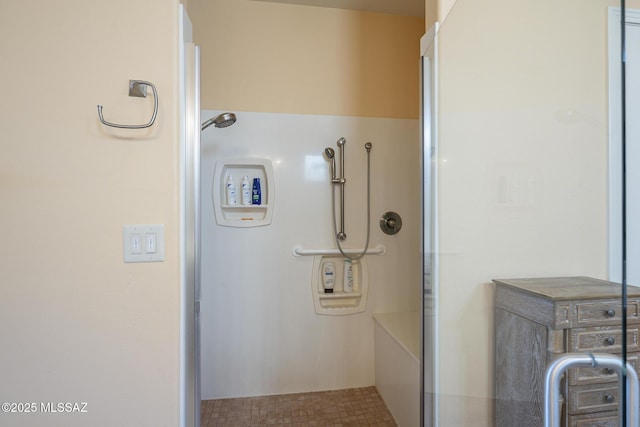 bathroom with a shower with door