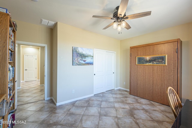 interior space with ceiling fan