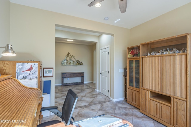 office with light tile patterned floors and ceiling fan