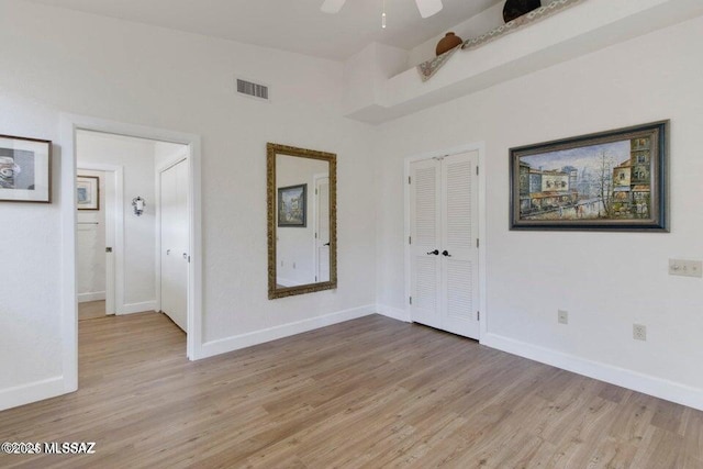 empty room featuring ceiling fan and light wood-type flooring