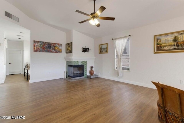 living room featuring vaulted ceiling, ceiling fan, a multi sided fireplace, and hardwood / wood-style floors