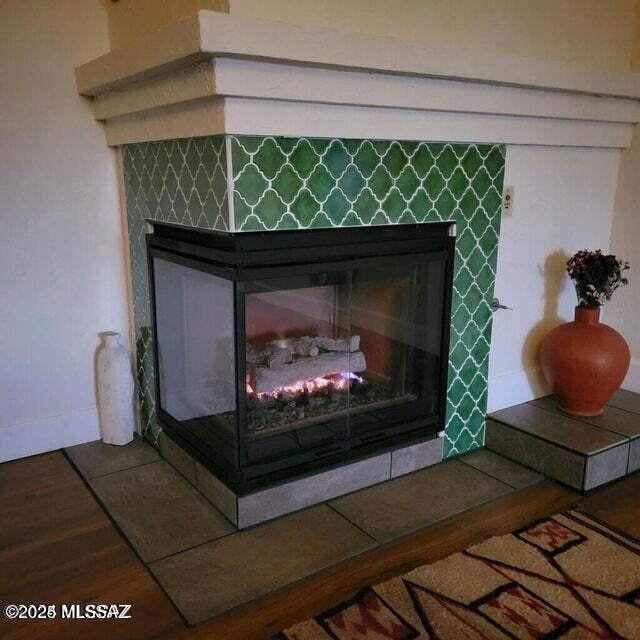 interior details with hardwood / wood-style flooring and a fireplace