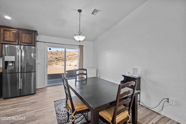 kitchen with a kitchen island, decorative light fixtures, and dark brown cabinetry