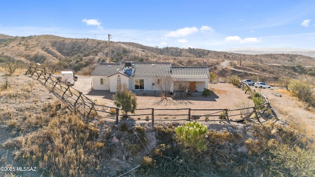 back of property with a mountain view and central AC