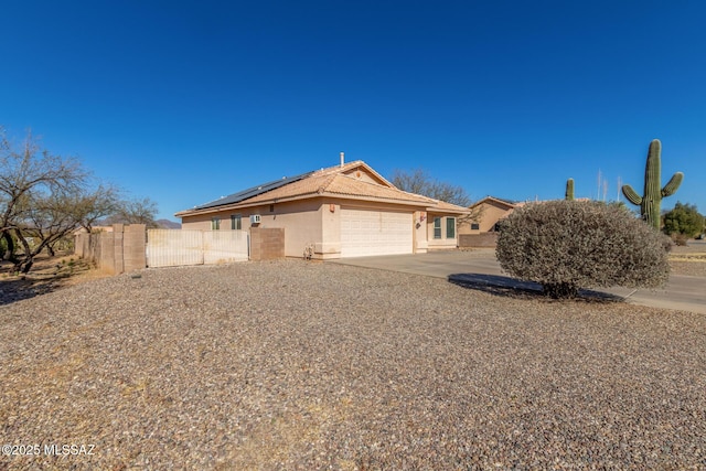 single story home featuring a garage and solar panels