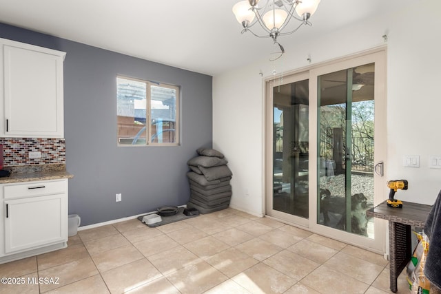 tiled dining area featuring an inviting chandelier