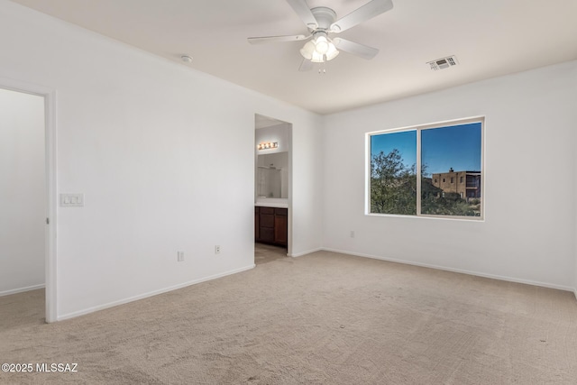 unfurnished bedroom with ceiling fan, ensuite bathroom, and light colored carpet