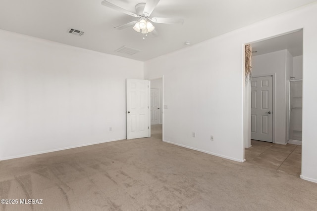 carpeted spare room with ceiling fan