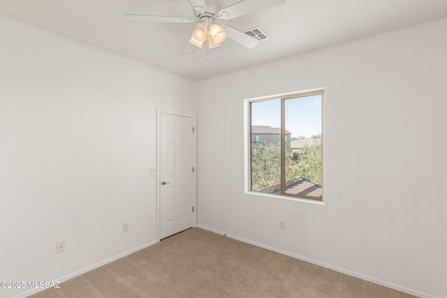 unfurnished room featuring ceiling fan and light colored carpet