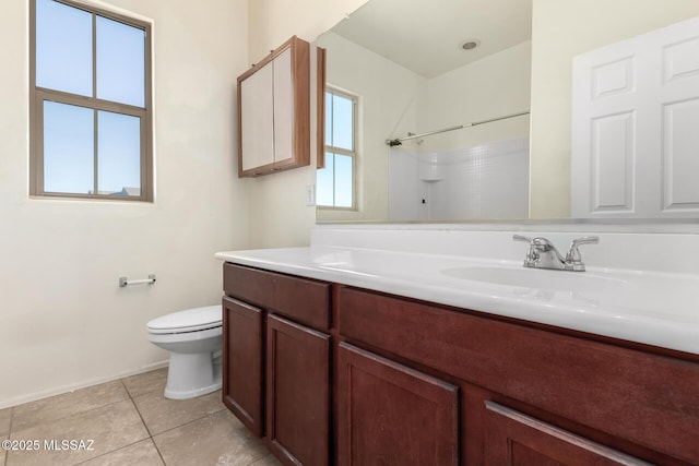 bathroom featuring a shower, toilet, vanity, and tile patterned flooring